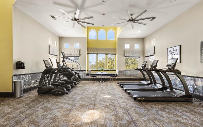 a room with treadmills and a large window