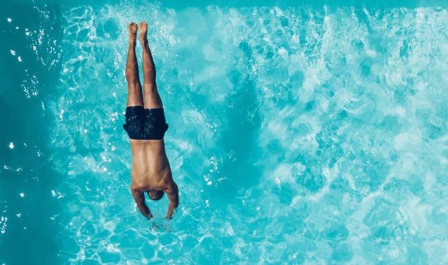 Shimmering resort-style pool a man swimming in the water