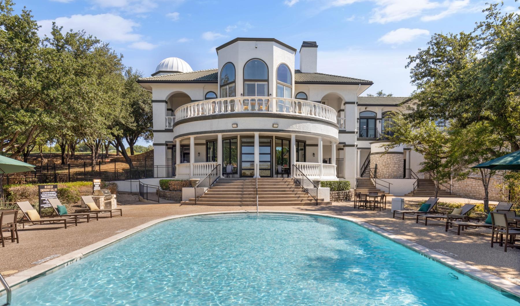 a large white house with a pool
