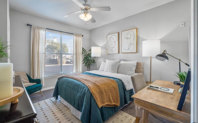 a bedroom with a bed and a fan