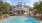 a large white house with a pool