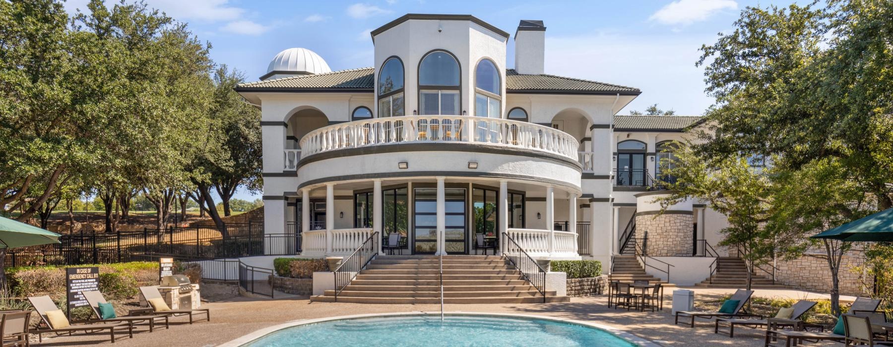 a large white house with a pool